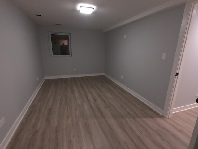 unfurnished room with hardwood / wood-style floors