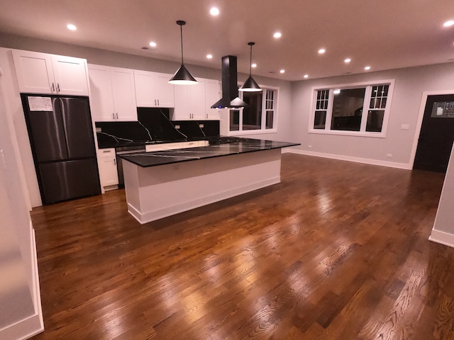 kitchen with white cabinetry, dark hardwood / wood-style flooring, stainless steel fridge, decorative light fixtures, and island range hood