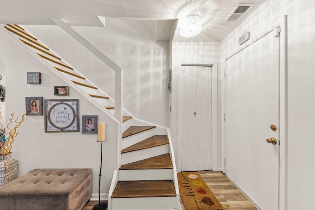 stairs featuring wood-type flooring