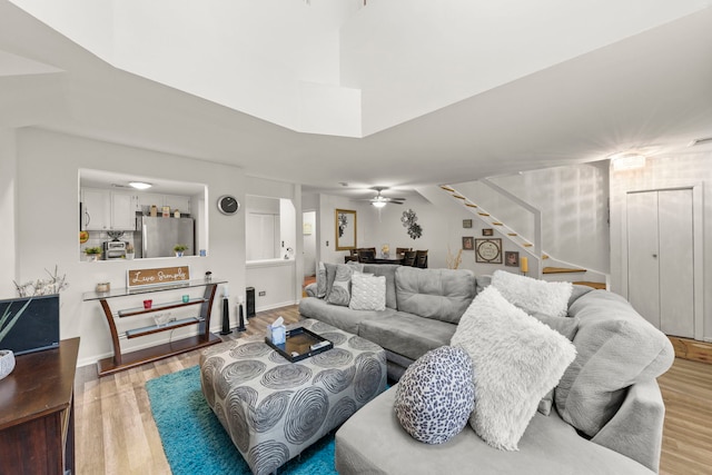 living room with ceiling fan and light wood-type flooring