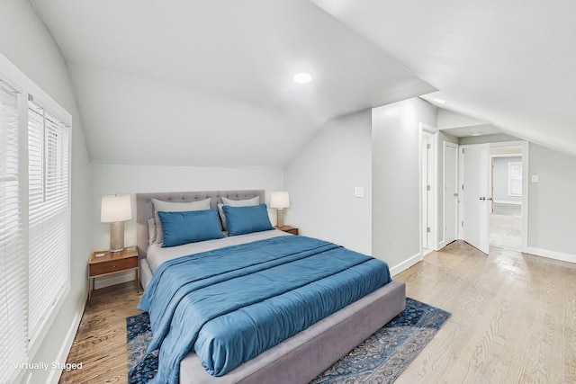 bedroom with hardwood / wood-style flooring and lofted ceiling