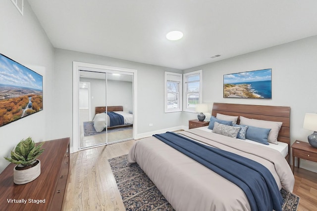 bedroom with hardwood / wood-style floors and a closet