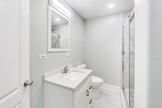 bathroom featuring vanity, toilet, and an enclosed shower