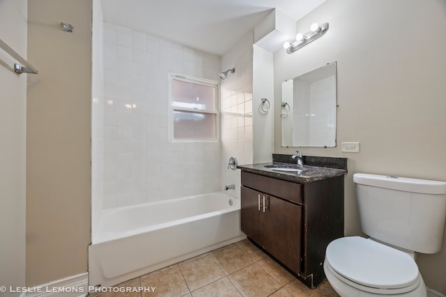 full bathroom featuring tile patterned floors, vanity, tiled shower / bath, and toilet