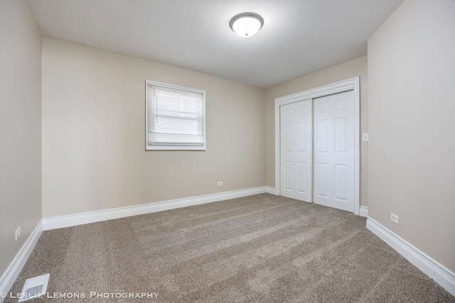 unfurnished bedroom featuring a closet and carpet