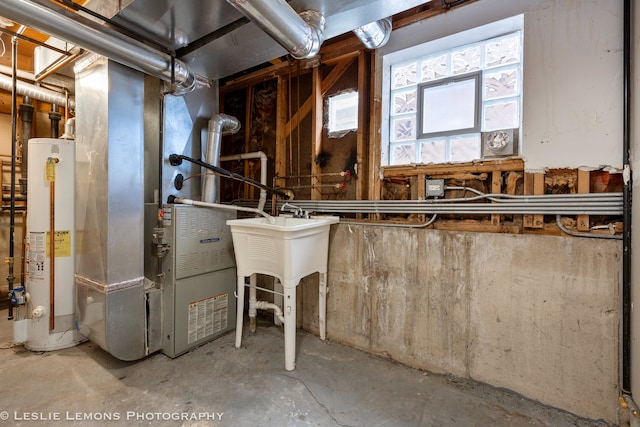 utility room with heating unit and gas water heater