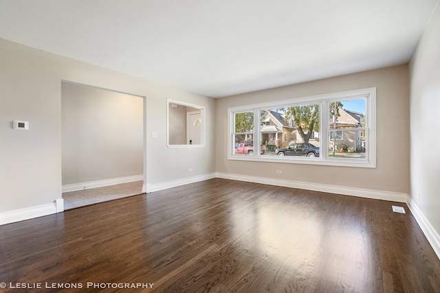 empty room featuring dark wood-type flooring