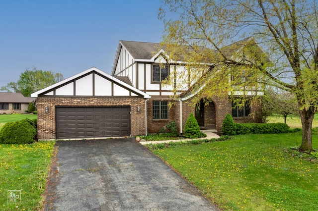 tudor house with a front yard and a garage