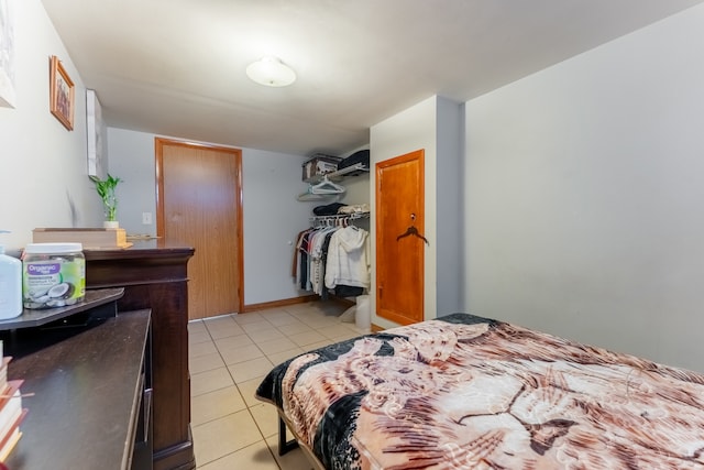 tiled bedroom with a closet