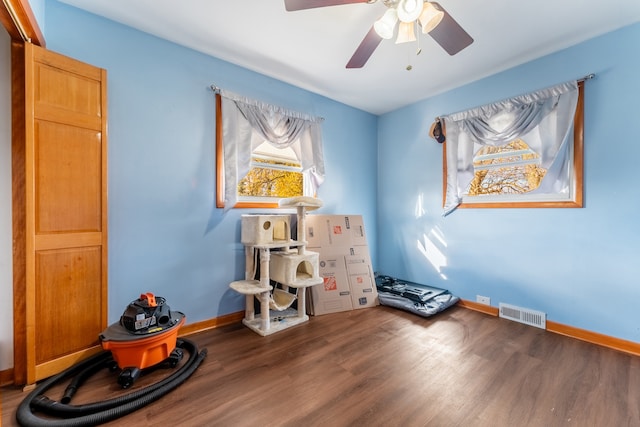 misc room with ceiling fan and dark hardwood / wood-style floors