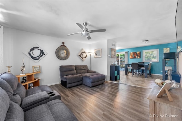 living room with wood-type flooring and ceiling fan