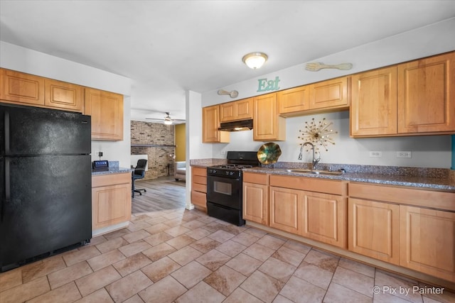 kitchen featuring black appliances, ceiling fan, built in desk, and sink