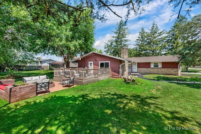 back of house featuring outdoor lounge area, a yard, a patio, and a wooden deck