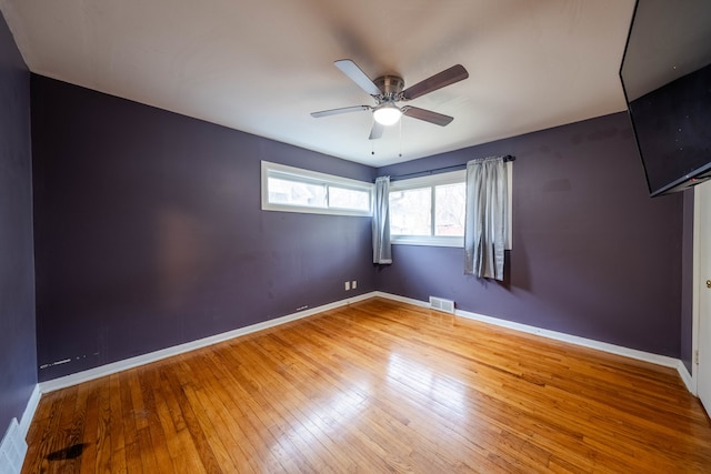 spare room with hardwood / wood-style flooring and ceiling fan