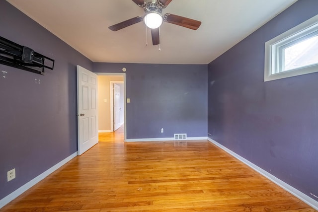 615 W Union St, Champaign, IL 61820 - spare room featuring visible vents, baseboards, a ceiling fan, and hardwood / wood-style flooring