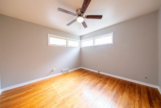 615 W Union St, Champaign, IL 61820 - unfurnished room with baseboards, a healthy amount of sunlight, visible vents, and wood finished floors