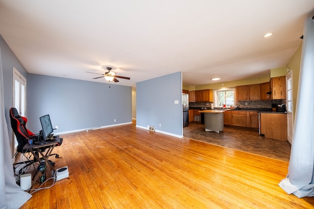 living room with ceiling fan and light hardwood / wood-style floors