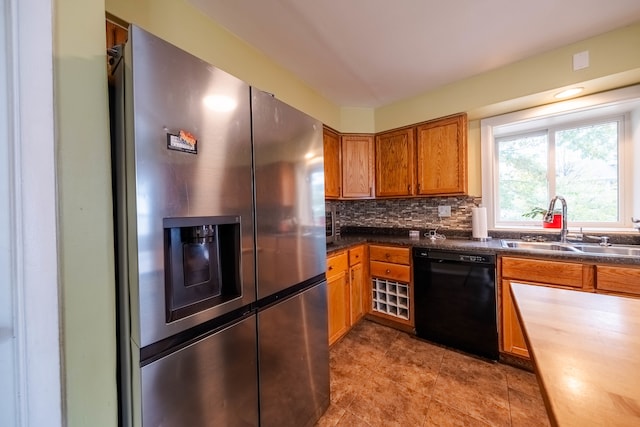 kitchen featuring backsplash, black dishwasher, sink, and stainless steel refrigerator with ice dispenser