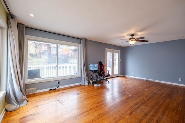 empty room featuring ceiling fan, french doors, and hardwood / wood-style flooring