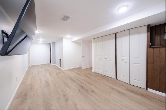 basement with light hardwood / wood-style floors