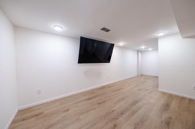 basement with light hardwood / wood-style flooring