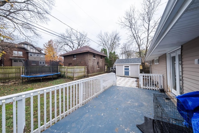 view of patio with a trampoline and a storage unit