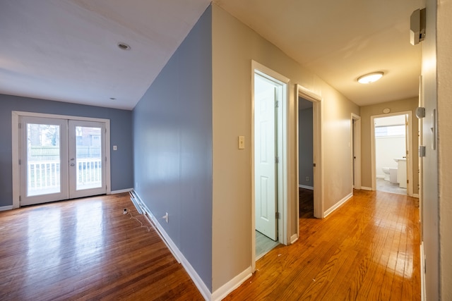 hallway featuring hardwood / wood-style floors and french doors