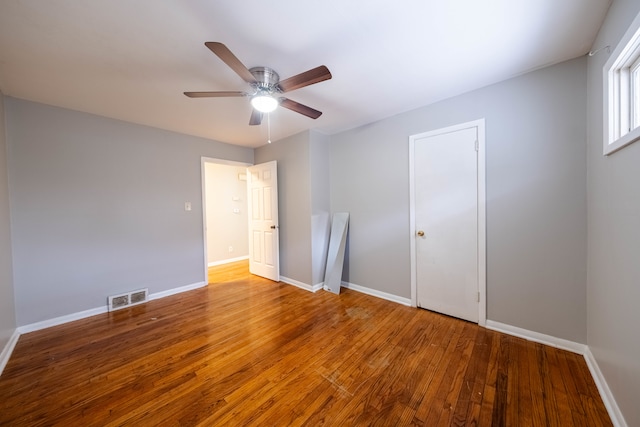 empty room featuring wood-type flooring and ceiling fan