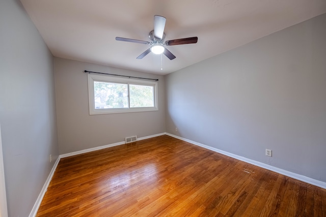 unfurnished room with wood-type flooring and ceiling fan