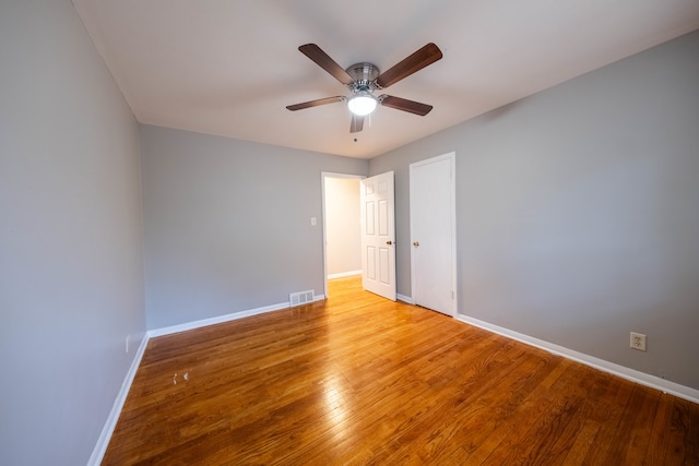 spare room featuring ceiling fan and hardwood / wood-style floors