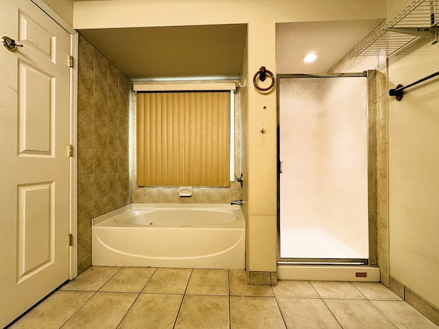 bathroom with tile patterned floors and independent shower and bath