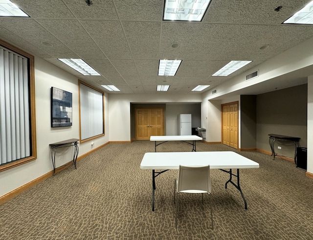 rec room featuring dark colored carpet and a paneled ceiling