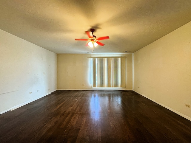 unfurnished room with a textured ceiling, dark hardwood / wood-style floors, and ceiling fan