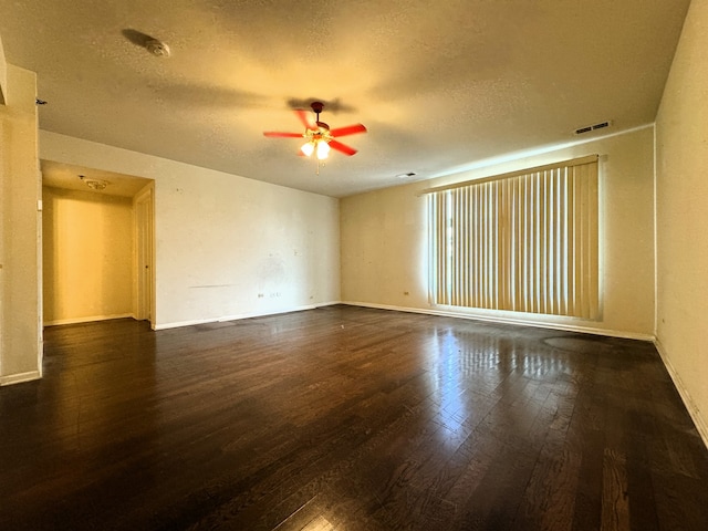 unfurnished room with a textured ceiling, dark hardwood / wood-style floors, and ceiling fan