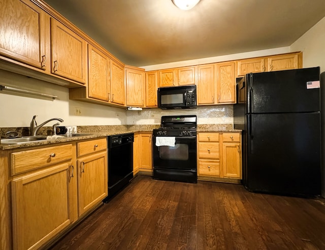 kitchen with backsplash, dark wood-type flooring, black appliances, and sink