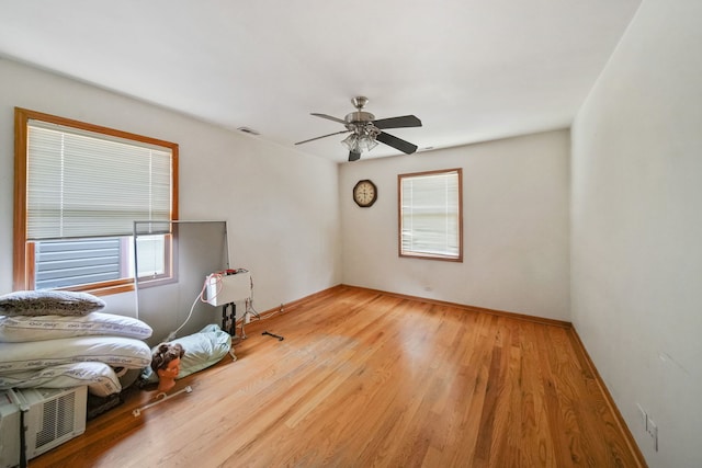 bedroom with hardwood / wood-style floors and ceiling fan