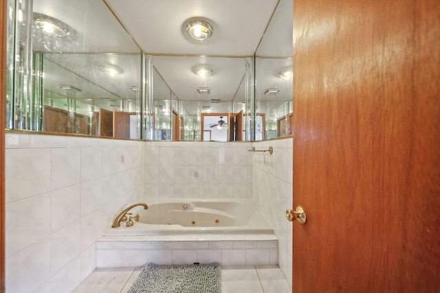 bathroom with tile patterned flooring and tiled bath