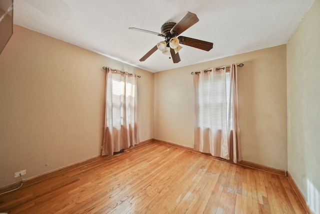 unfurnished room with ceiling fan and hardwood / wood-style flooring