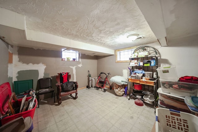 basement with a textured ceiling and a wealth of natural light