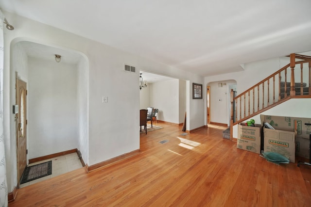 interior space with light hardwood / wood-style flooring and a notable chandelier