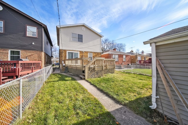 back of house featuring a yard and a wooden deck