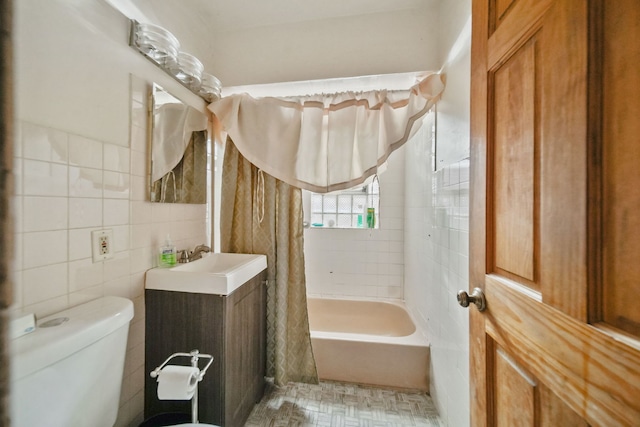 full bathroom featuring shower / bath combo, toilet, tile walls, and sink