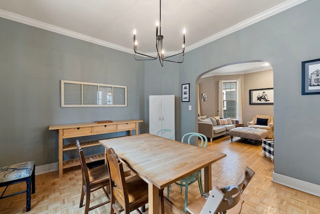 dining area featuring a notable chandelier, ornamental molding, and light parquet floors