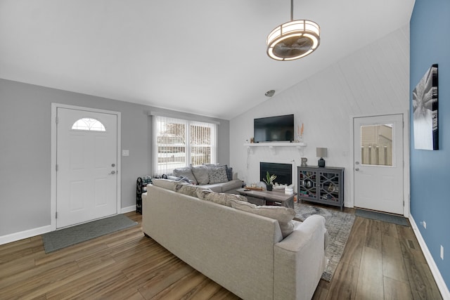 living room with wood-type flooring and vaulted ceiling