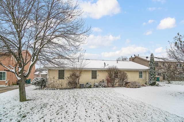 view of snow covered rear of property