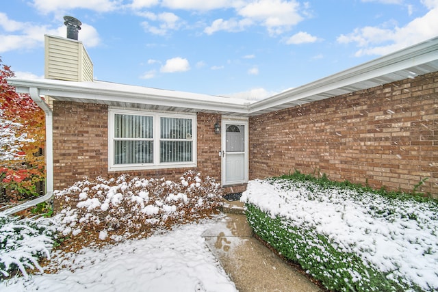 view of snow covered property entrance