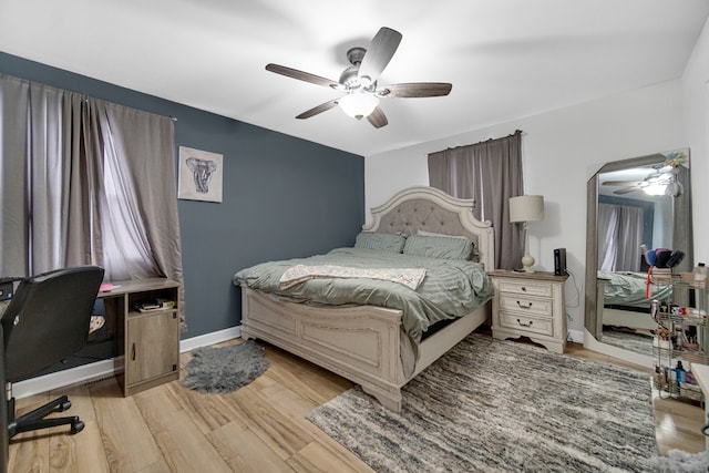 bedroom with light hardwood / wood-style flooring and ceiling fan