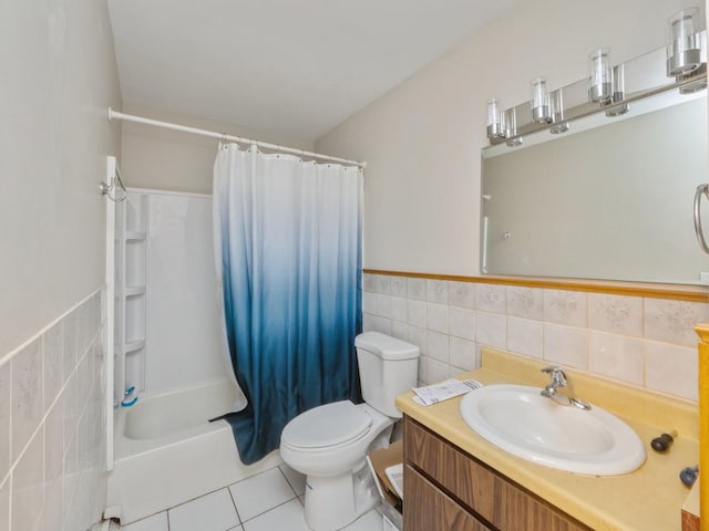 full bathroom featuring tile patterned floors, shower / bath combo with shower curtain, vanity, and tile walls