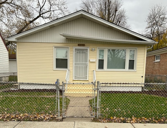 bungalow-style home with a front yard