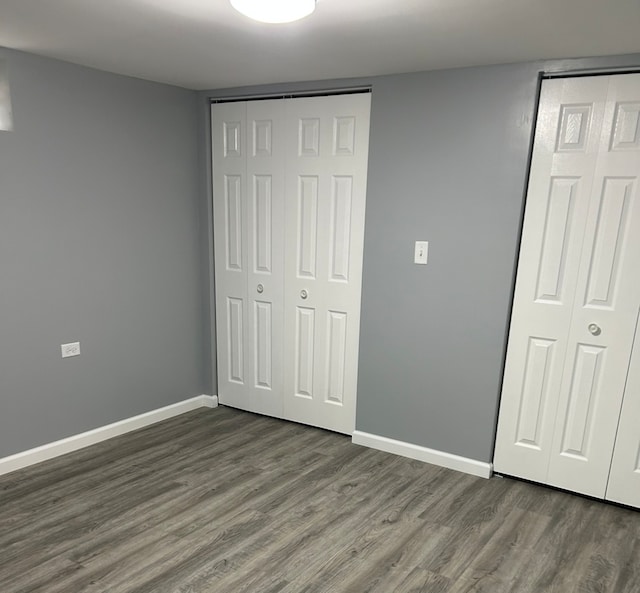 unfurnished bedroom with dark hardwood / wood-style floors